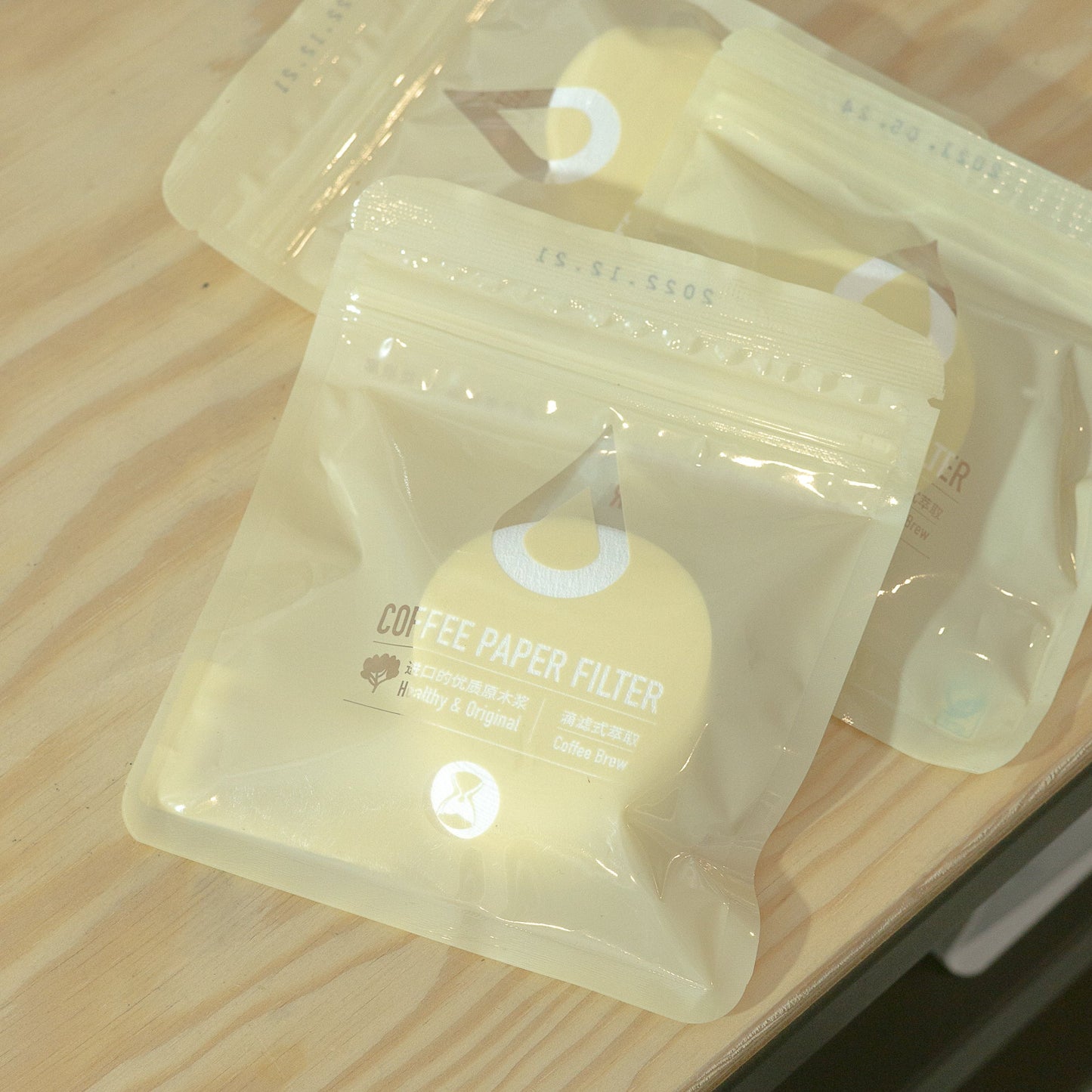 Clear plastic packaging with a yellow product on a wooden surface